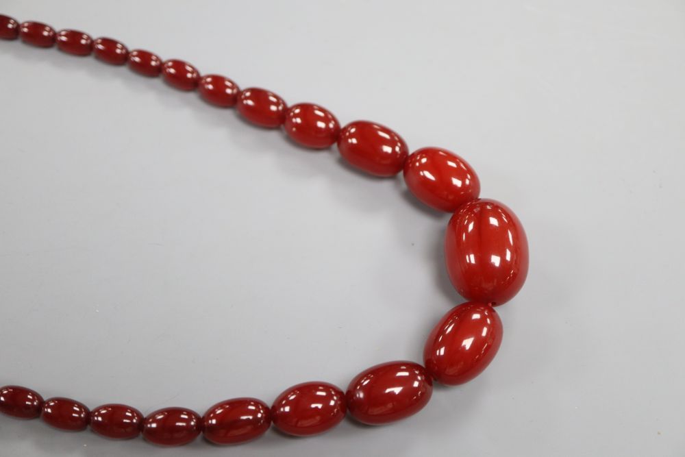 A single strand graduated cherry amber bead necklace, 75cm, gross 66 grams.
